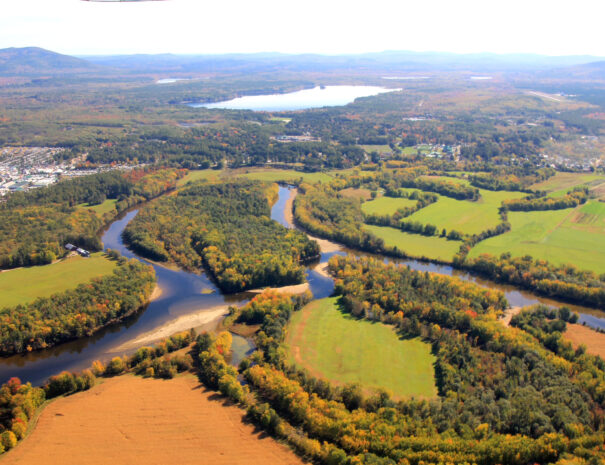 Fall scenic flight over the Saco River, Fryeburg, Maine looking to the White Mountains
